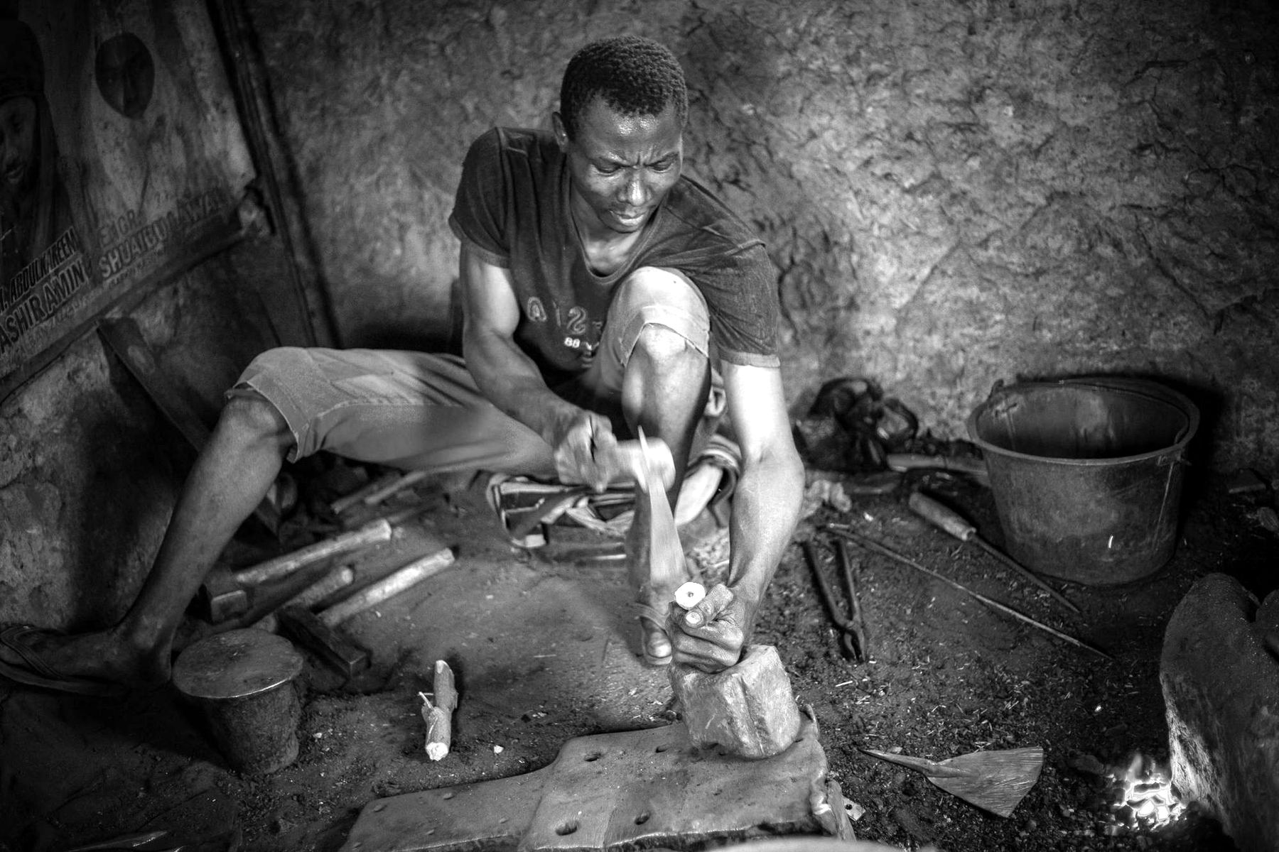 A metalworker forging in a workshop