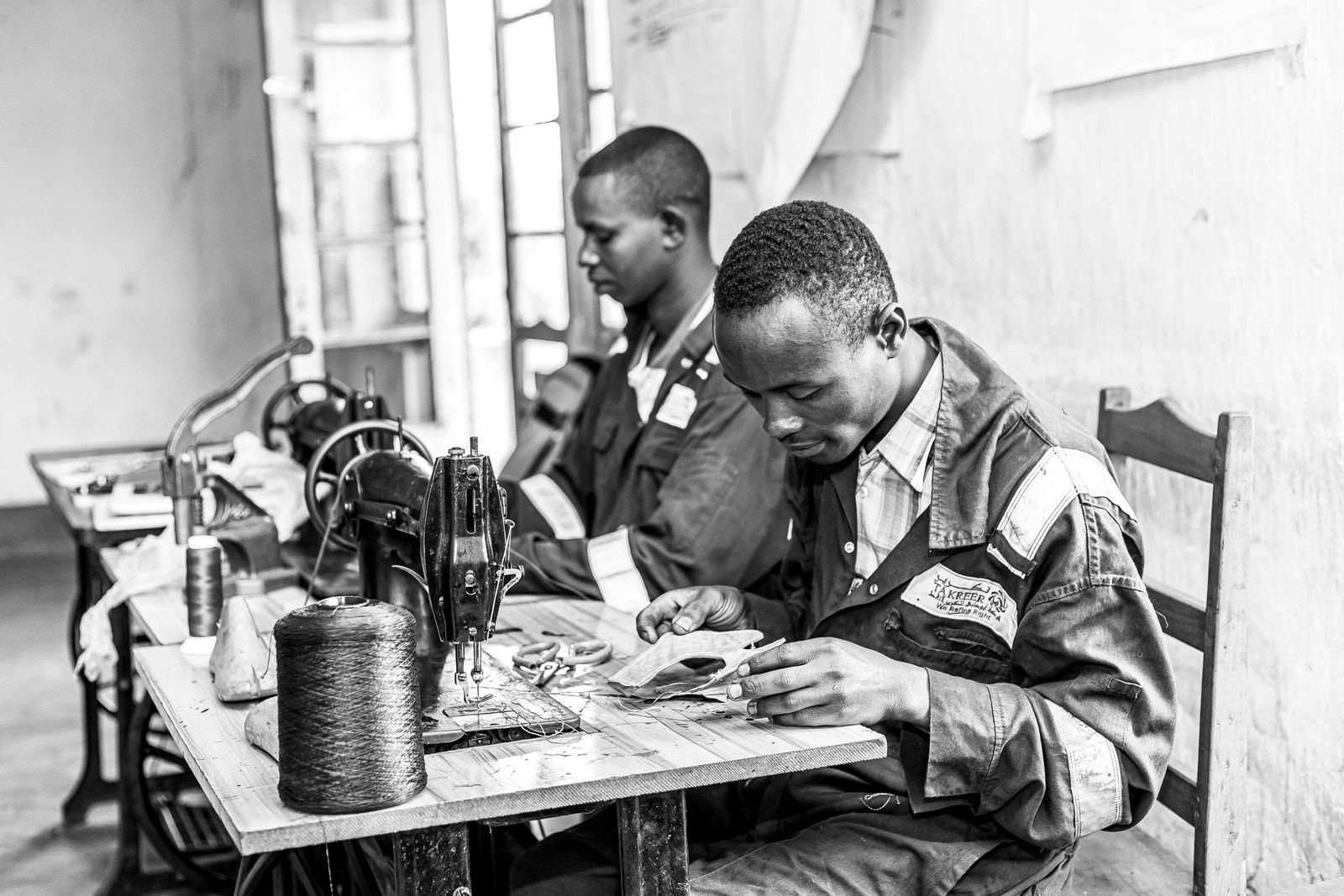 Two tailors at work in a workshop